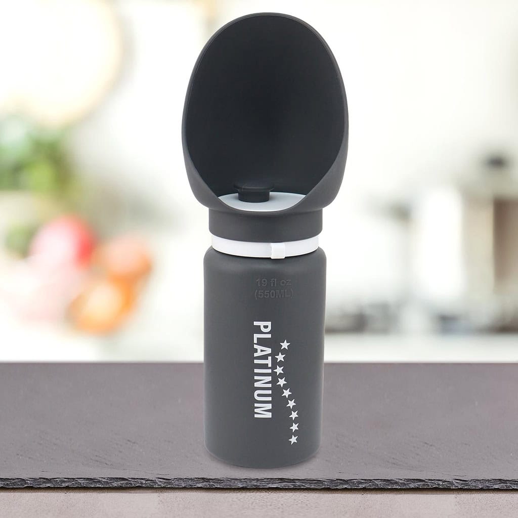 Siv Prenosni bidon z lijakom za pse blagovne znamke PLATINUM z vgrajeno posodo za vodo je postavljen na pult v zamegljenem notranjem okolju.